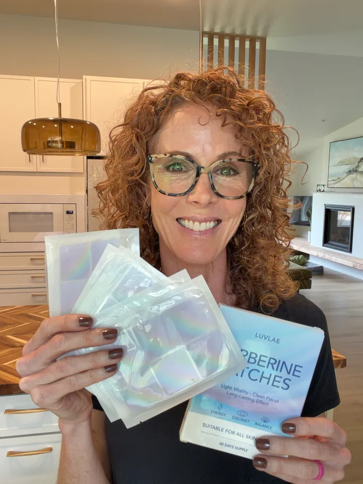 Woman with glasses holding a Luvlae box and several patch sheets